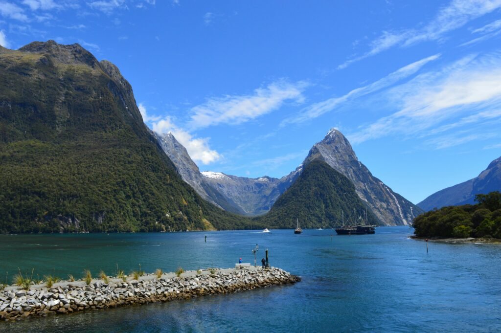 Stunning view of Milford Sound's scenic fjord with mountains and calm waters in New Zealand.